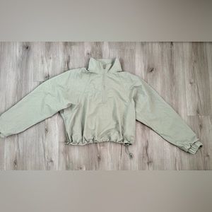 Mint green Alo windbreaker jacket, with drawstring.